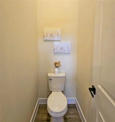 a white toilet sitting in a bathroom