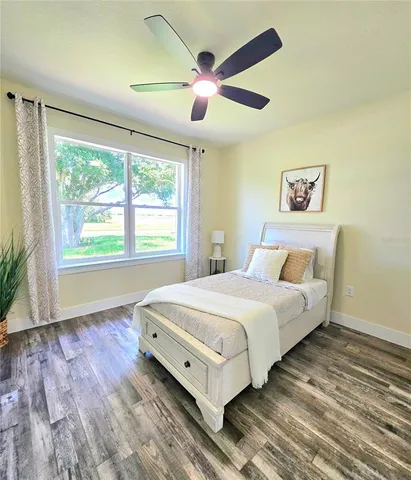 a bedroom with a large bed and a large window