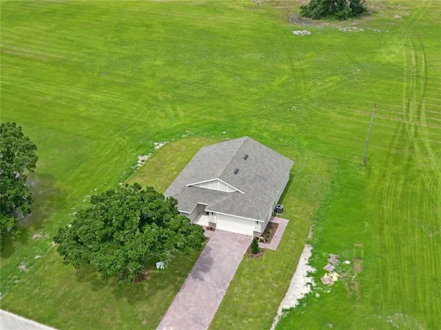 a aerial view of a house with a yard