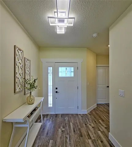 a view of a room with wooden floor closet and windows