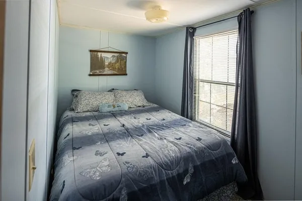 a bedroom with a bed and a window