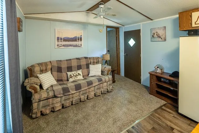 a spacious bedroom with a bed and a dresser