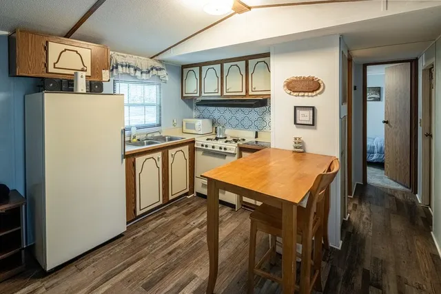 a kitchen with stainless steel appliances a stove a refrigerator a sink and cabinets