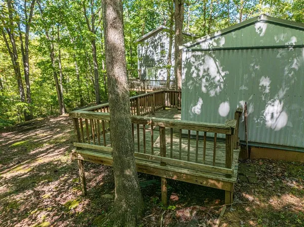 a view of a wooden deck with a yard