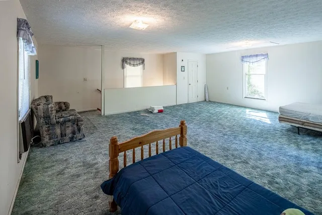 a bed room with a bed and a chair