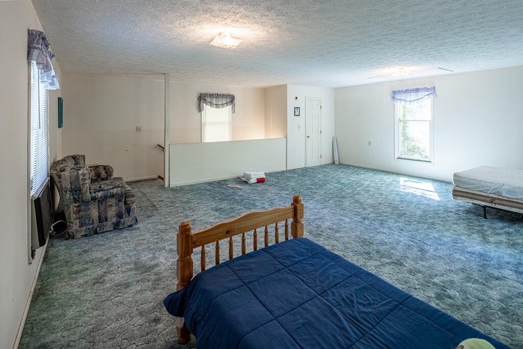 14 Riverview Avenue Buffalo Junction, VA 24529 - Photo 22 of 53 a bed room with a bed and a chair