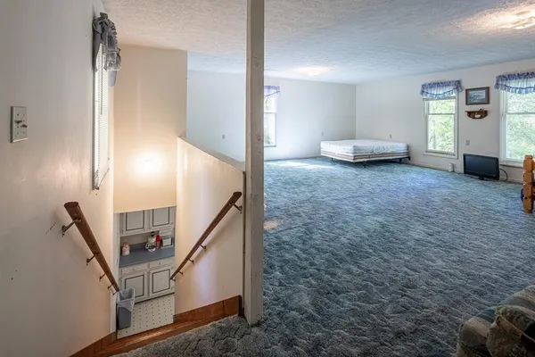 a view of a livingroom with furniture and stairs