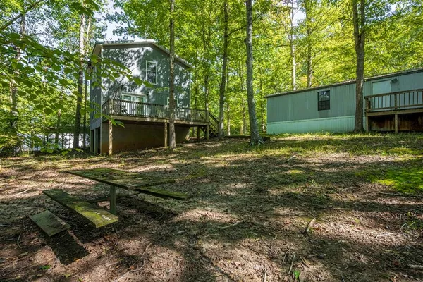 a view of a backyard with large trees