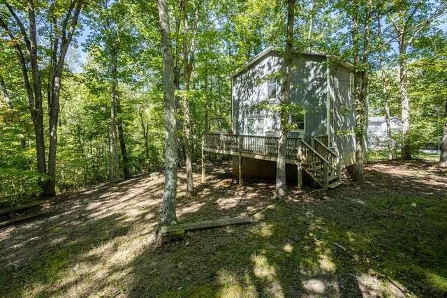 an aerial view of a house with a yard and lake view