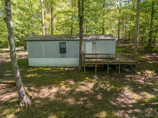 a view of house with backyard