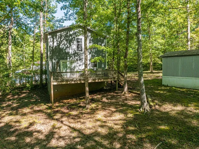 a view of a wooden house with a yard