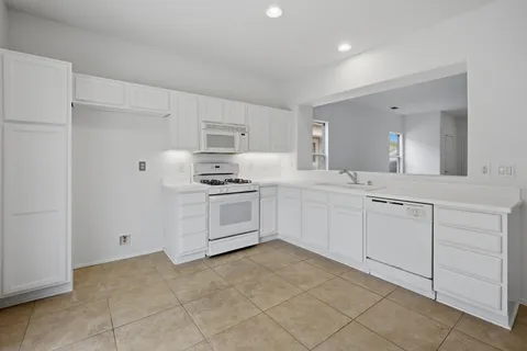 an empty room with a window and a ceiling fan