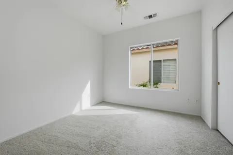 a bedroom with bed and a potted plant