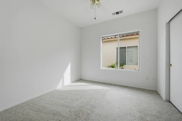 a bedroom with bed and a potted plant