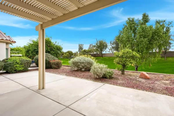 a view of a house with backyard and porch