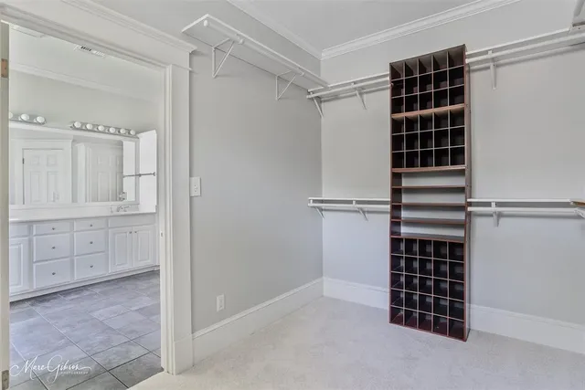 a view of walk in closet with empty racks