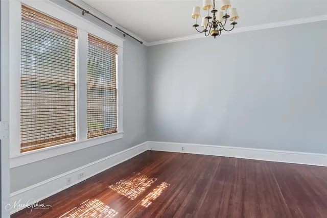 a view of a room with wooden floor and a window