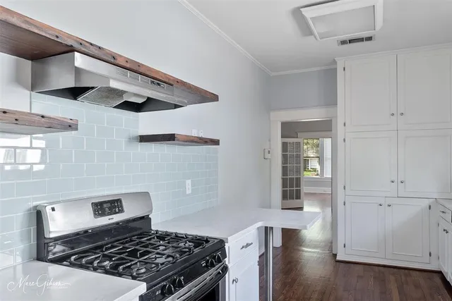 a kitchen with stainless steel appliances granite countertop a sink stove and cabinets