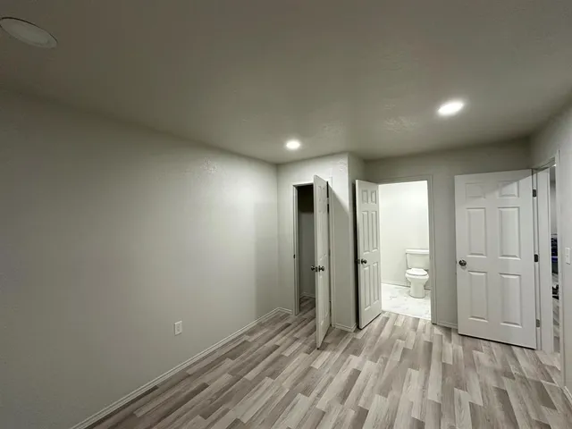 a view of a room with wooden floor and fan