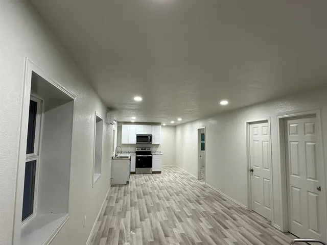 a view of kitchen with kitchen island microwave and stove top oven