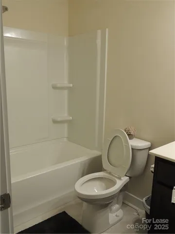 a bathroom with a toilet and a bathtub