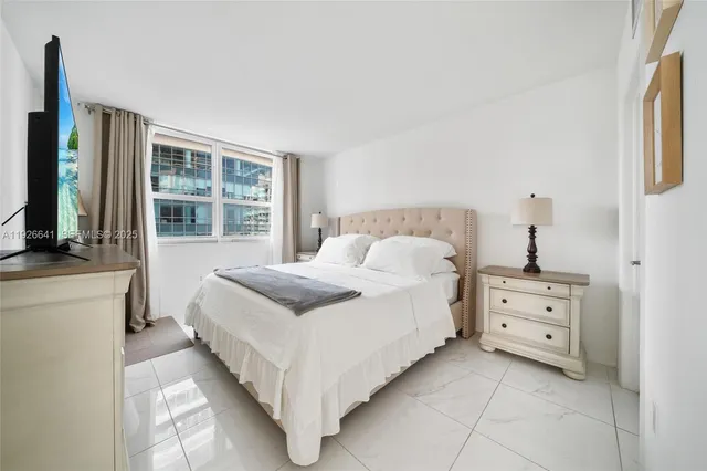 a bedroom with a bed a desk and chair