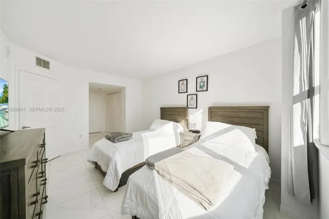 a bedroom with a bed and a balcony view