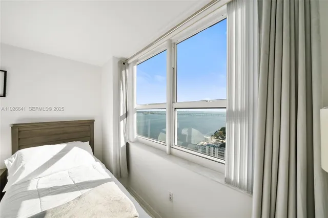 a bathroom with a sink toilet a mirror and shower