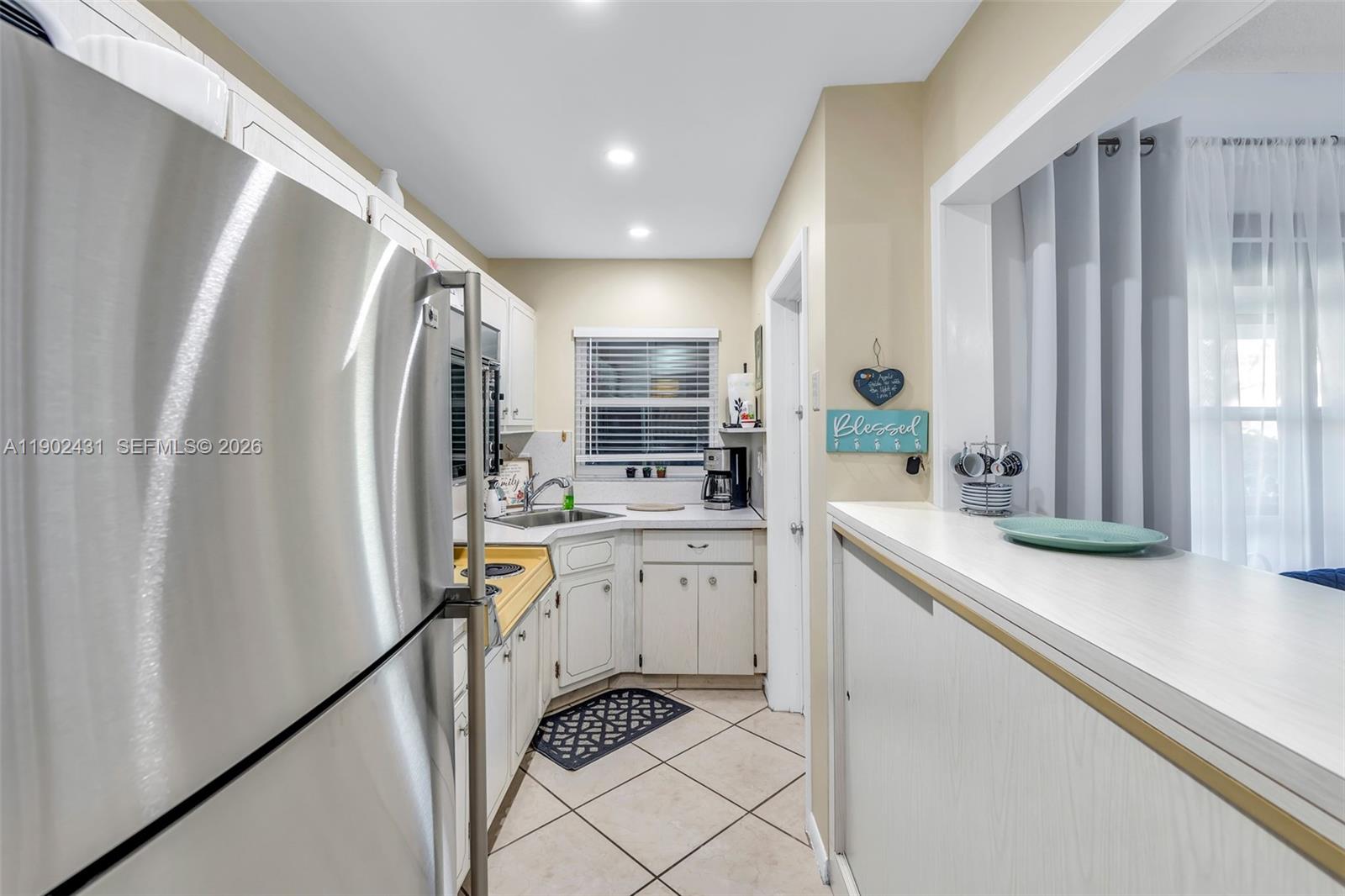 5300 Washington Street, Unit H137 Hollywood, FL 33021 - Photo 16 of 30 a kitchen with white cabinets and sink