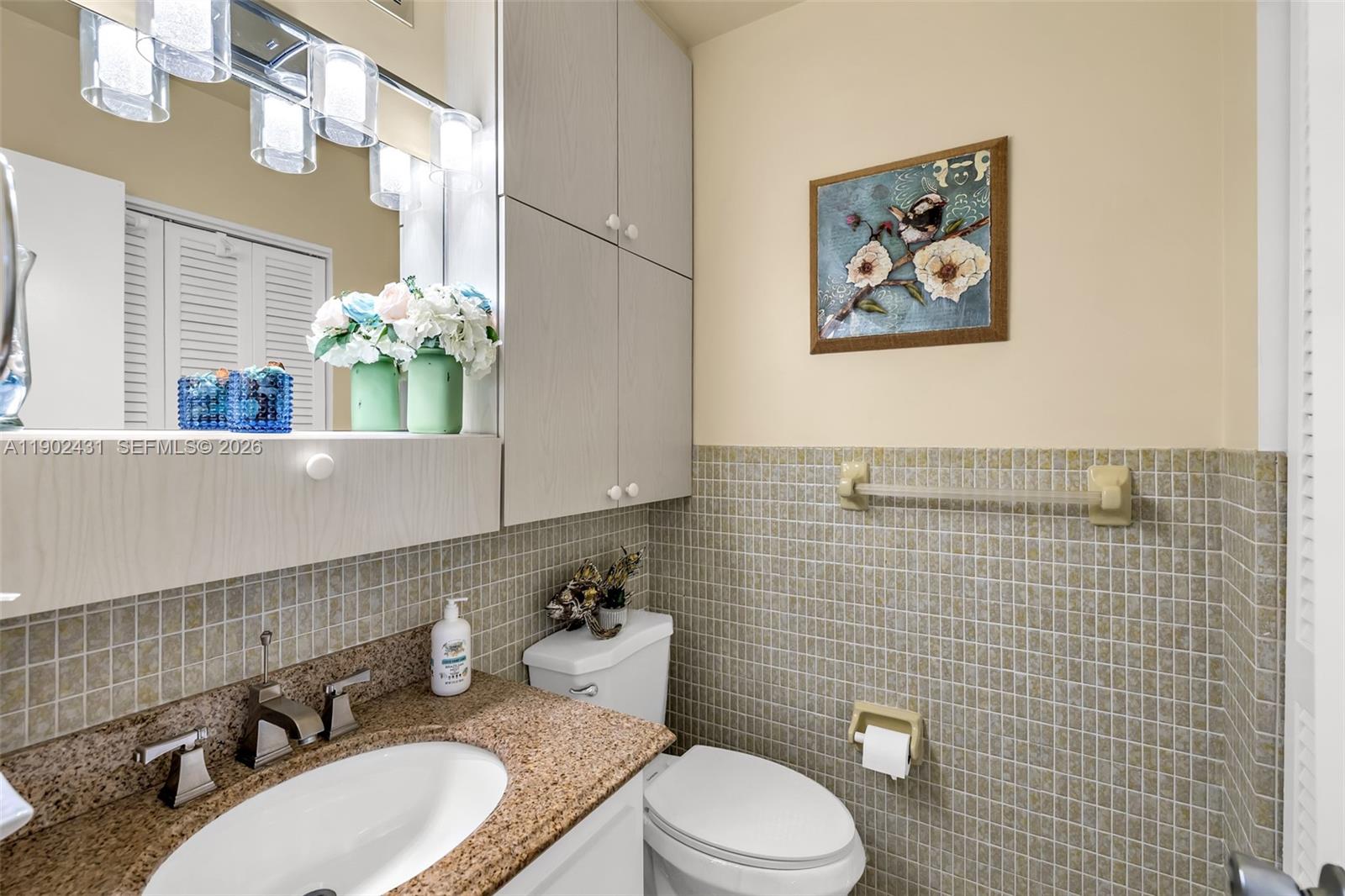 5300 Washington Street, Unit H137 Hollywood, FL 33021 - Photo 19 of 30 a bathroom with a toilet sink and mirror