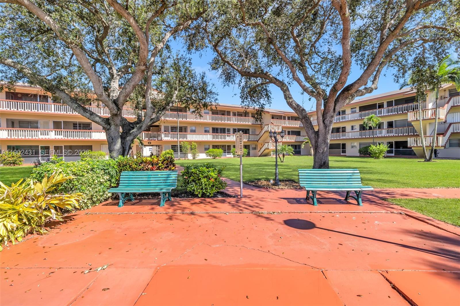 5300 Washington Street, Unit H137 Hollywood, FL 33021 - Photo 28 of 30 a garden with trees in front of it