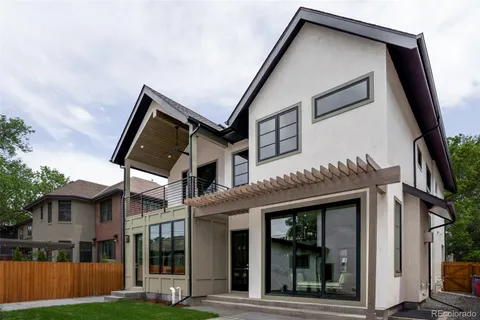 a view of house with backyard and glass windows