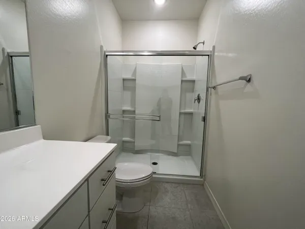 a bathroom with a shower a toilet and sink