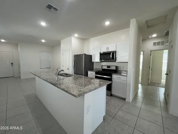 a large kitchen with a counter top space appliances and a center island