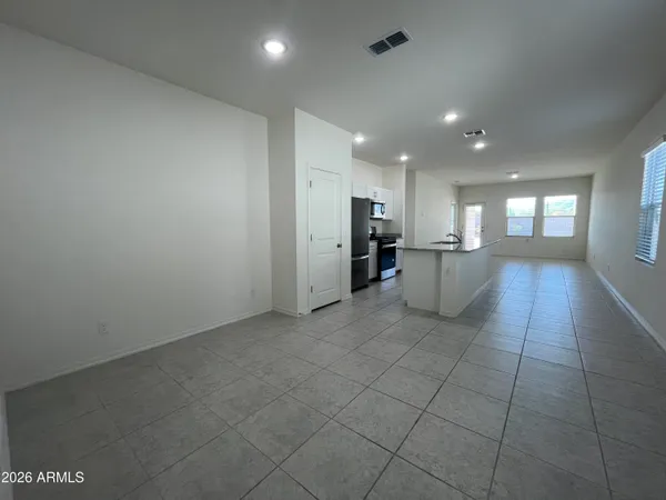 a view of a kitchen with a sink and a refrigerator