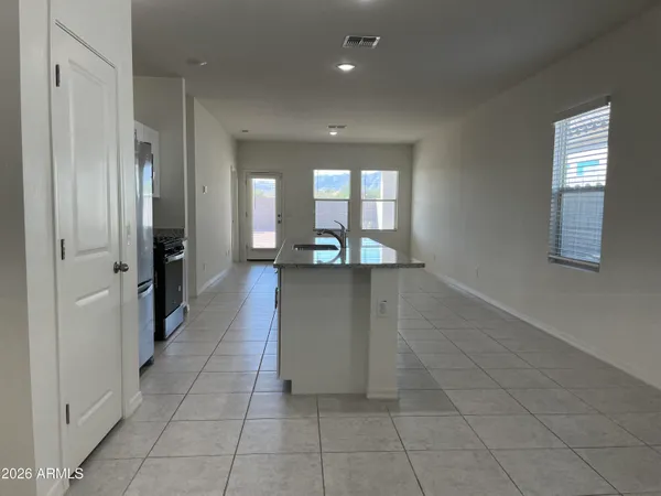 view of a hallway with wooden floor and a living room