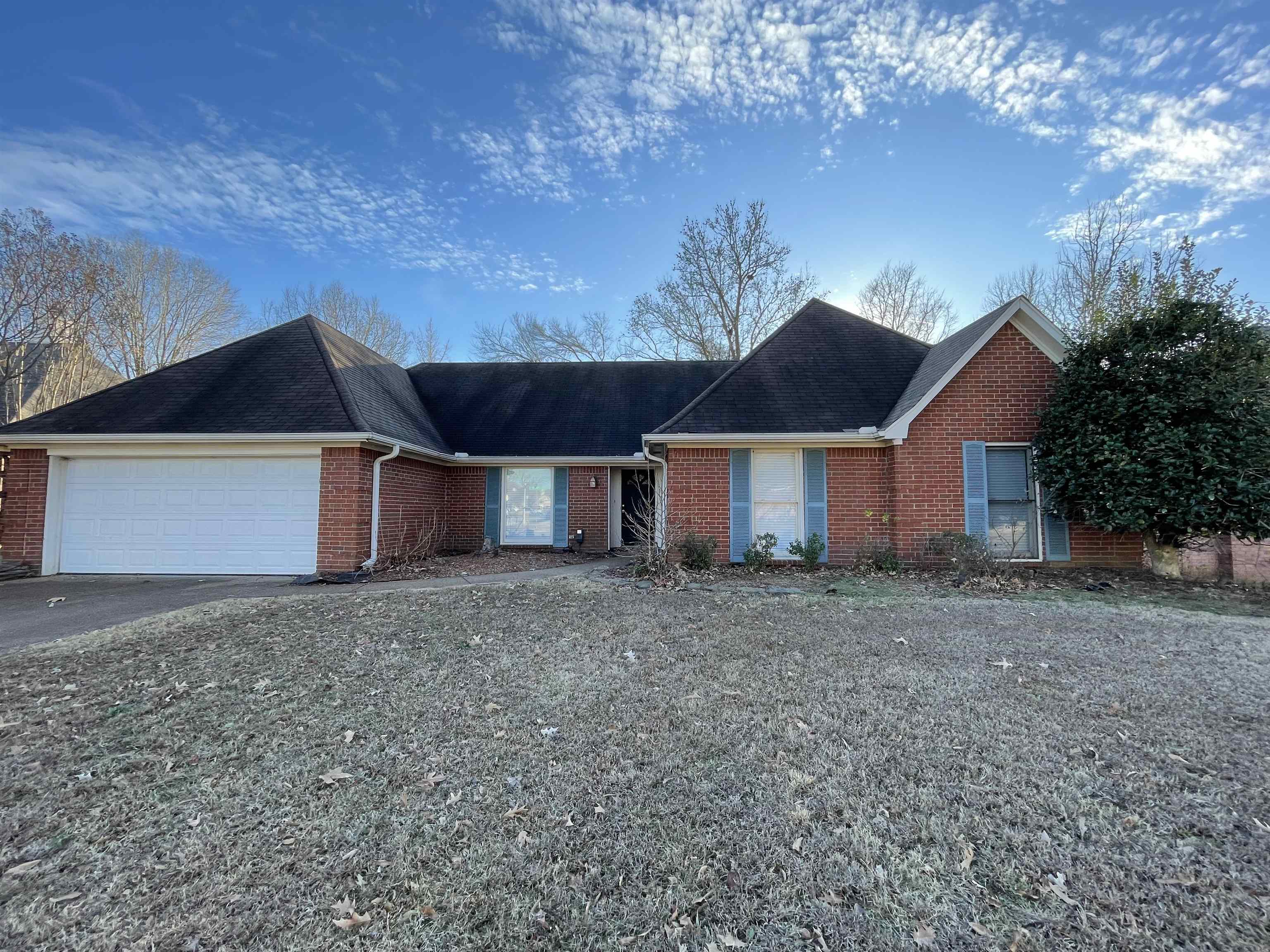 a front view of a house with a yard