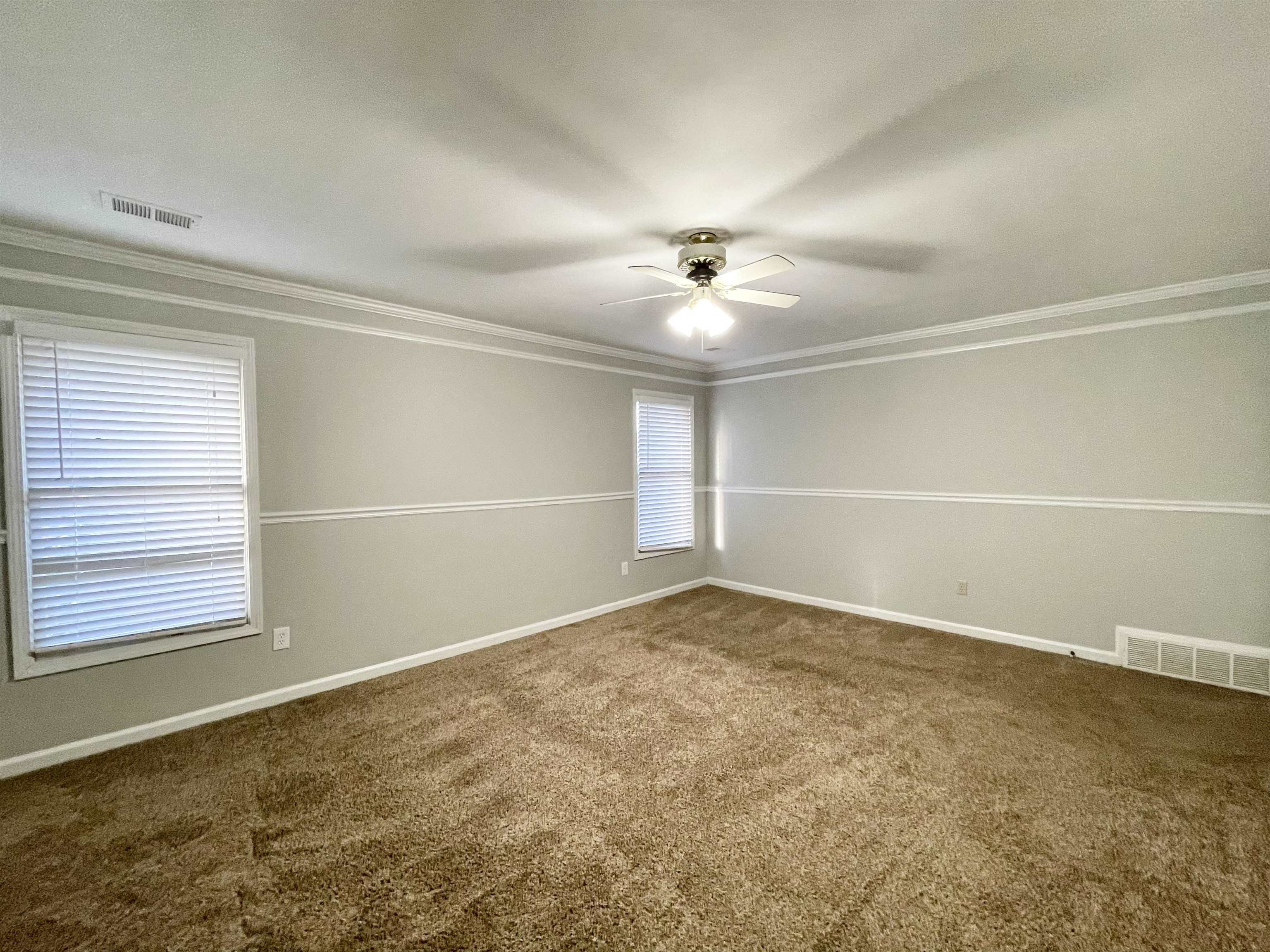 8859 Raspberry Lane Memphis, TN 38016 - Photo 11 of 16 an empty room with a empty space and windows