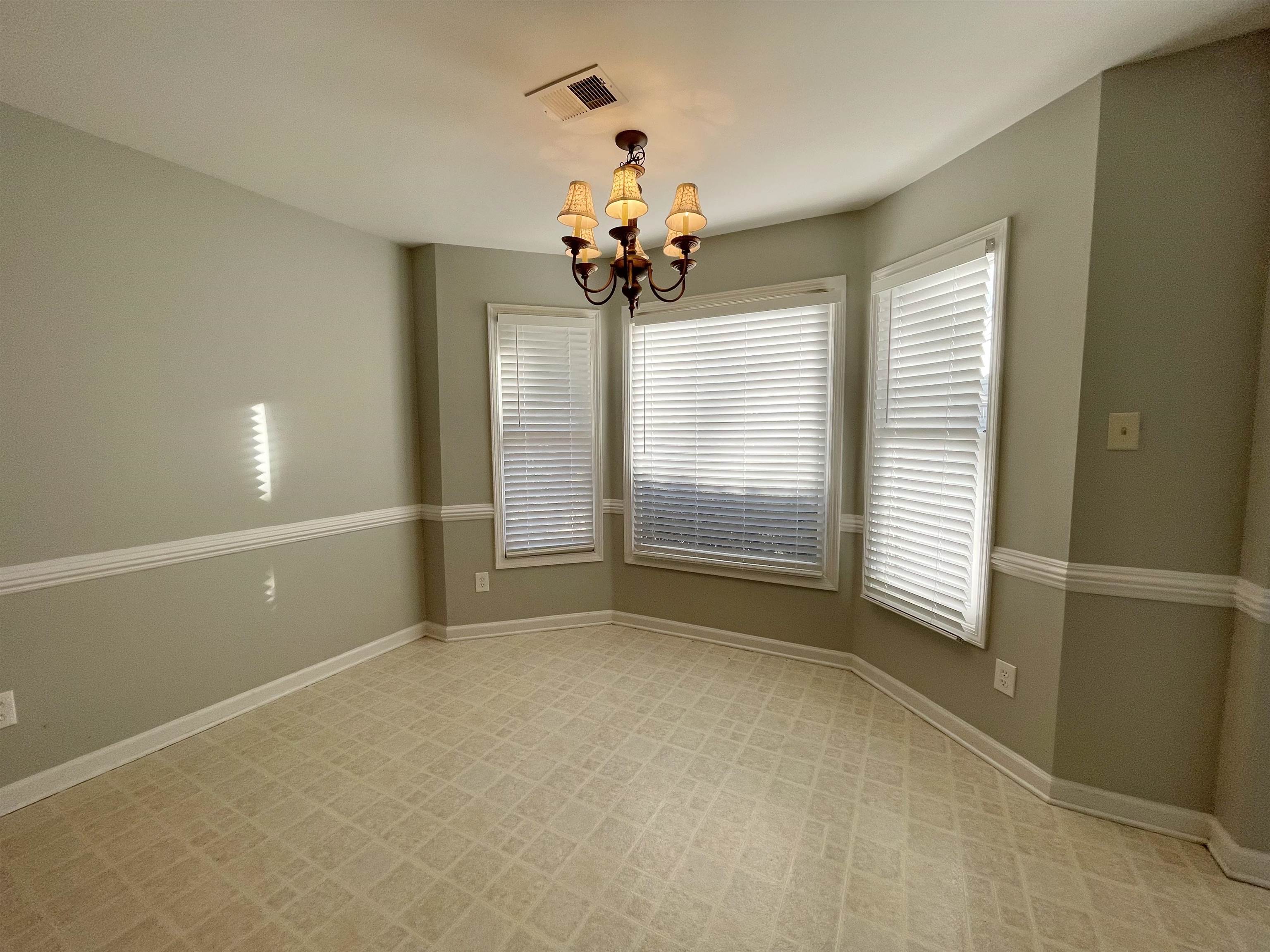 8859 Raspberry Lane Memphis, TN 38016 - Photo 7 of 16 a view of a livingroom with a chandelier