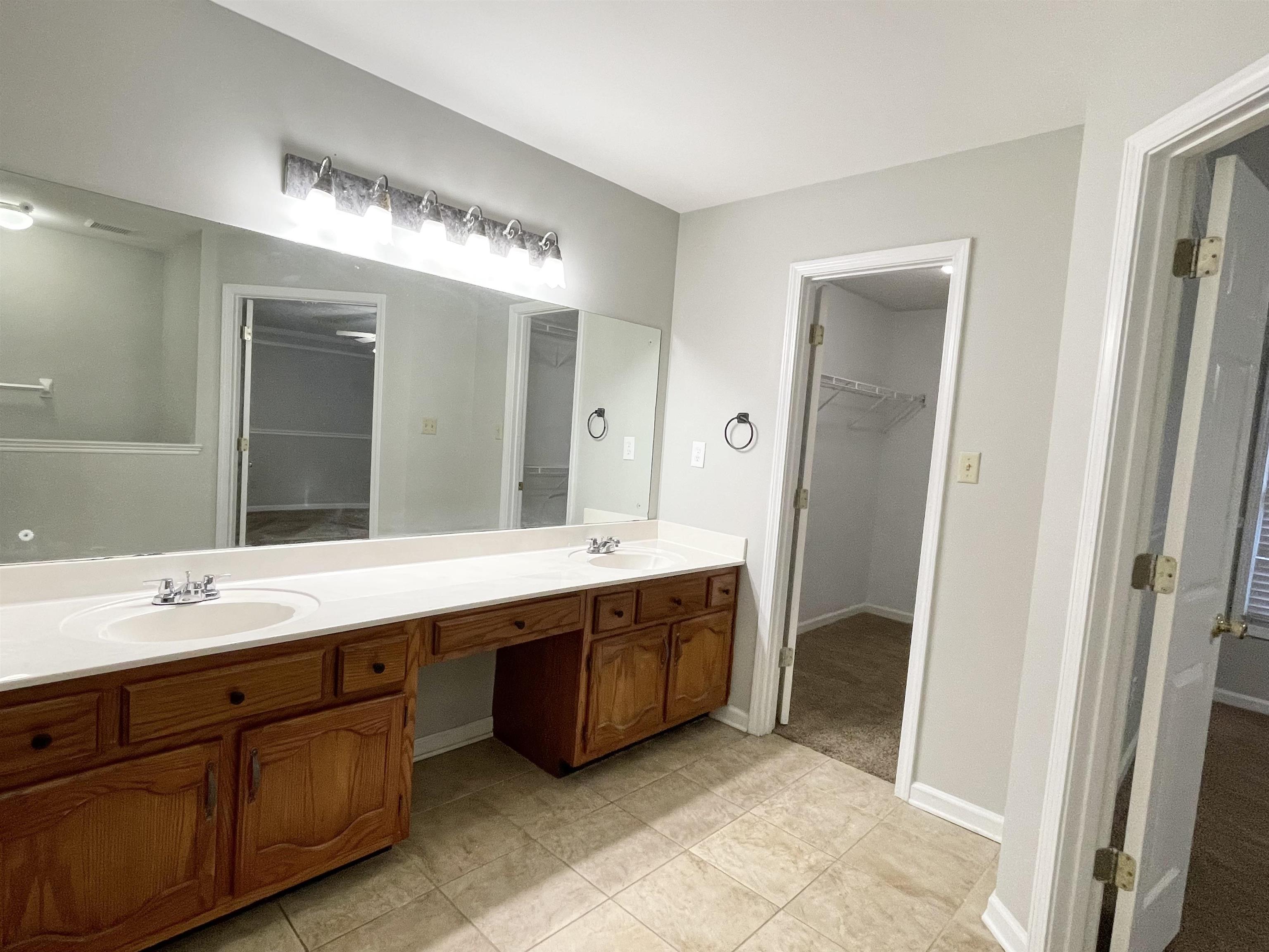 8859 Raspberry Lane Memphis, TN 38016 - Photo 8 of 16 a spacious bathroom with a double vanity sink mirror and double