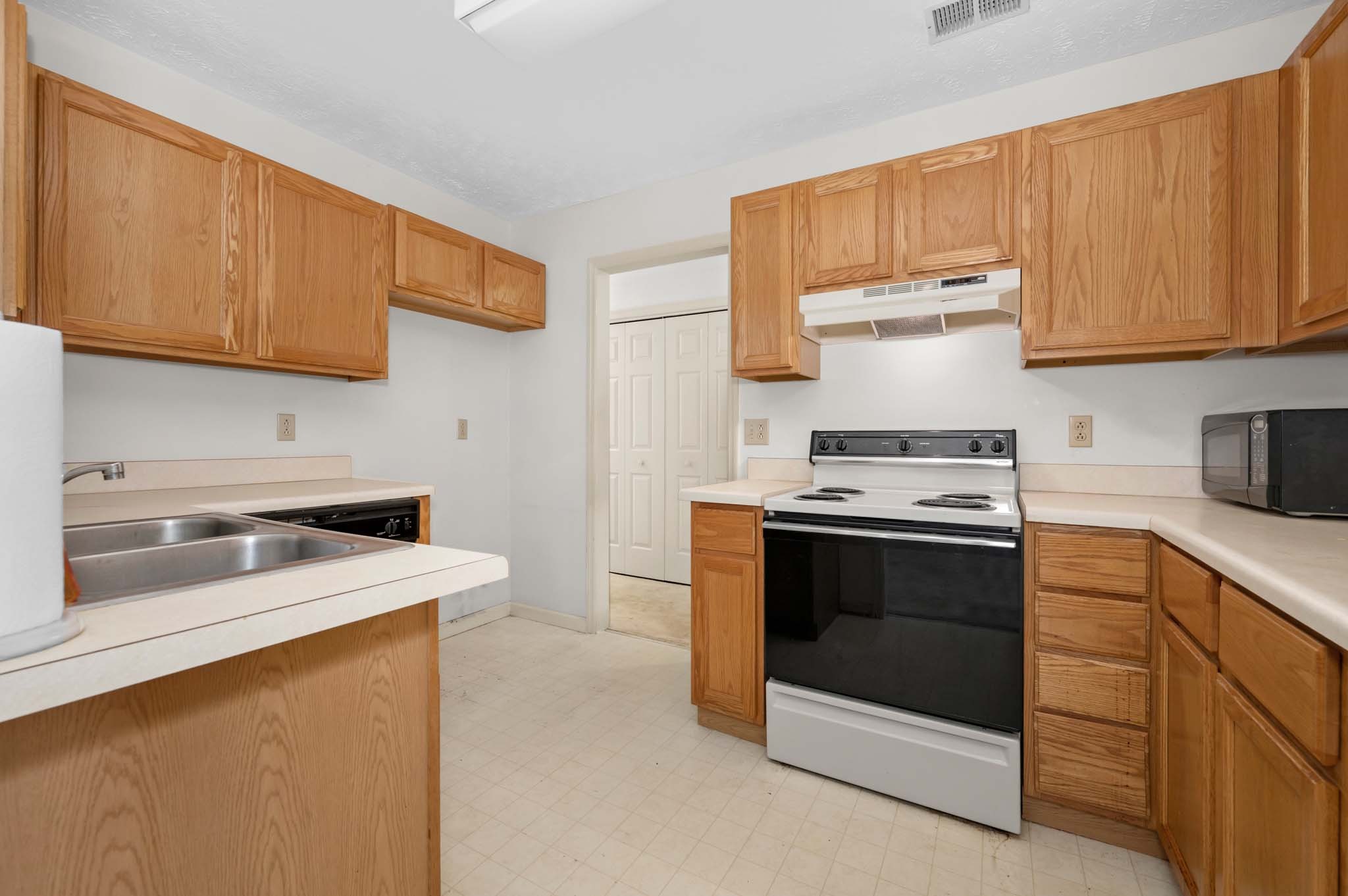 3624 Burwick Place Antioch, TN 37013 - Photo 13 of 31 a kitchen with stainless steel appliances granite countertop a stove a sink and a refrigerator