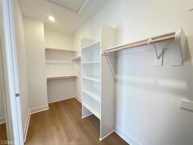 a view of walk in closet with empty racks