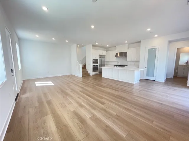 a view of kitchen with cabinets and wooden floor