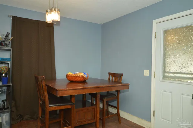 a dining room with furniture and window