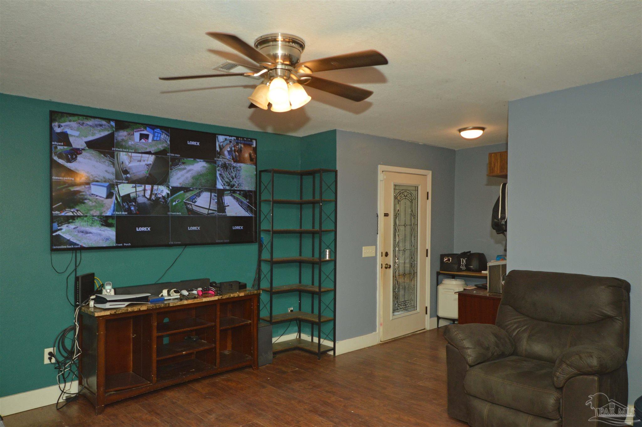 4163 Woodville Road Milton, FL 32583 - Photo 18 of 35 a living room with furniture and a flat screen tv
