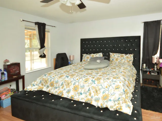 a bed sitting in a bedroom next to a window