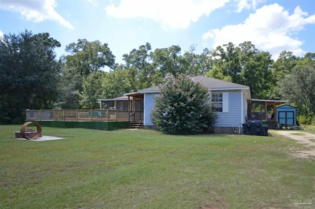 a view of a house with a yard and sitting area