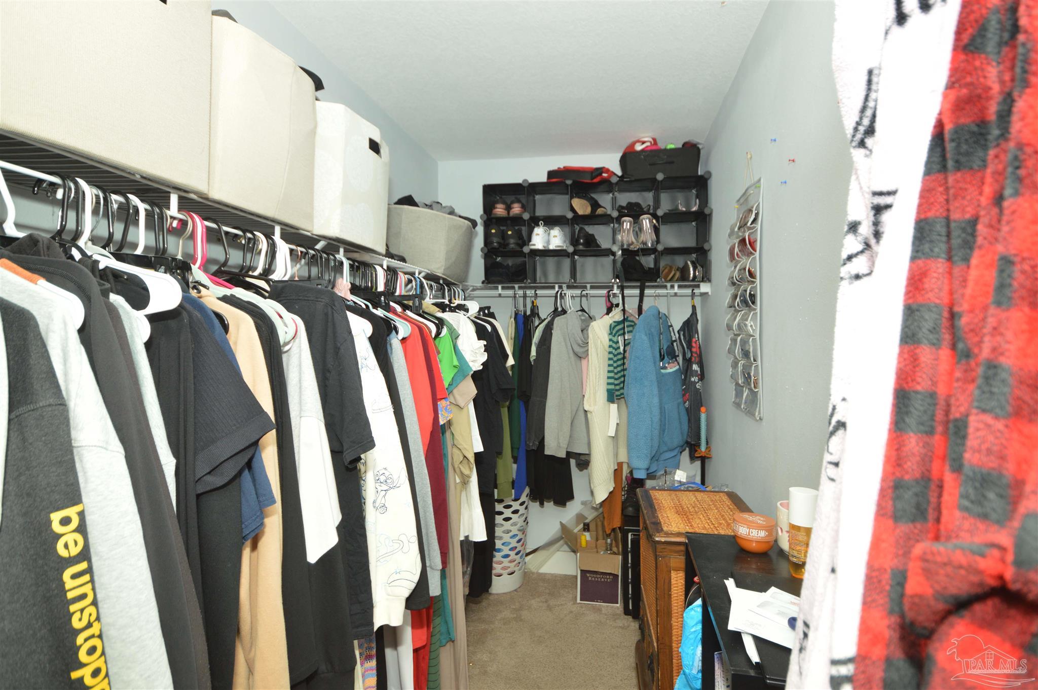 4163 Woodville Road Milton, FL 32583 - Photo 23 of 35 a view of walk in closet with clothes