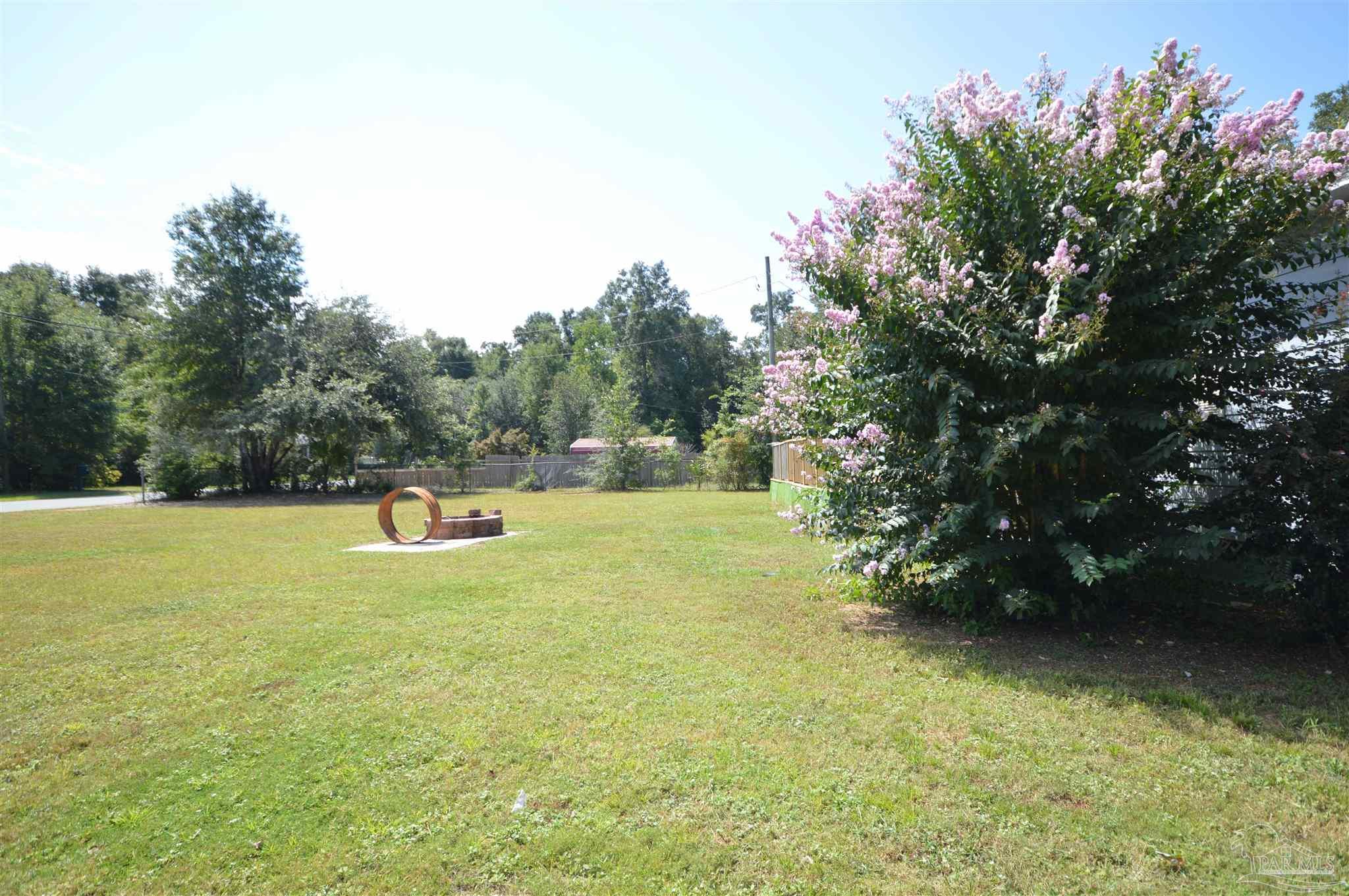 4163 Woodville Road Milton, FL 32583 - Photo 7 of 35 a view of a swimming pool with a yard