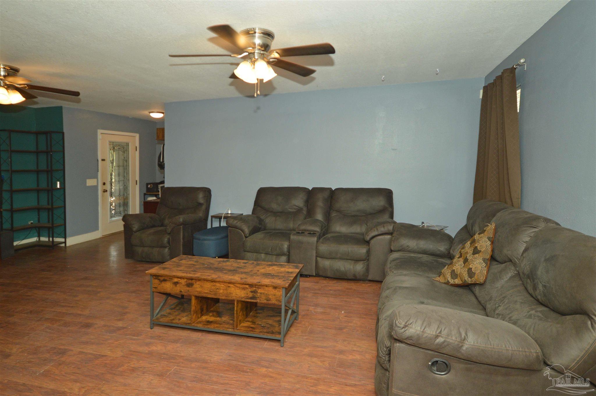 4163 Woodville Road Milton, FL 32583 - Photo 9 of 35 a living room with furniture